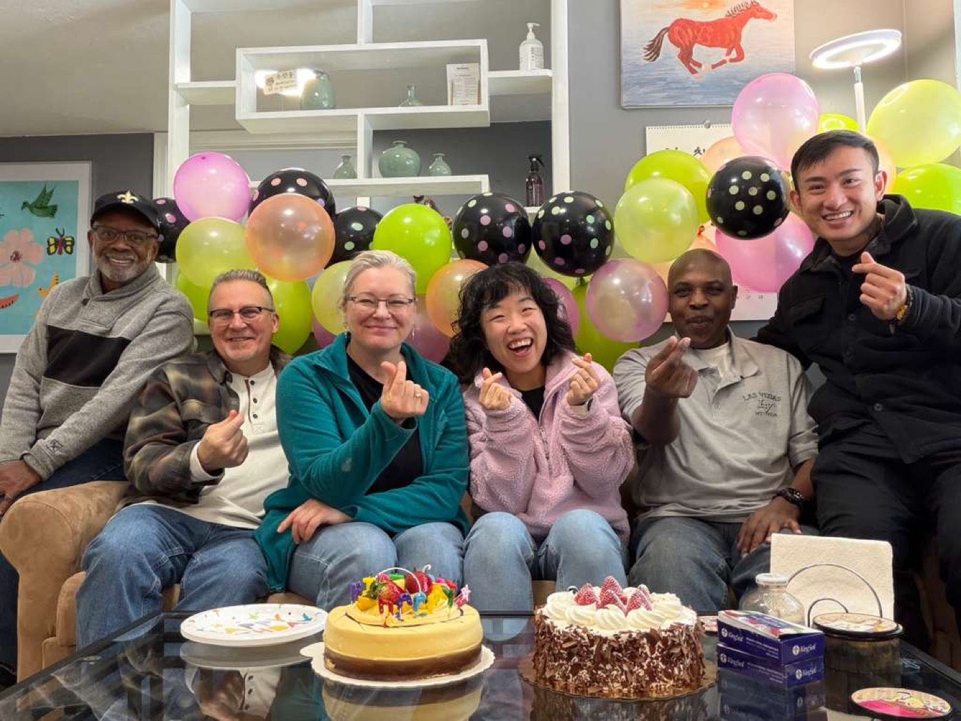 Members celebrating a birthday at the center with cakes and balloons