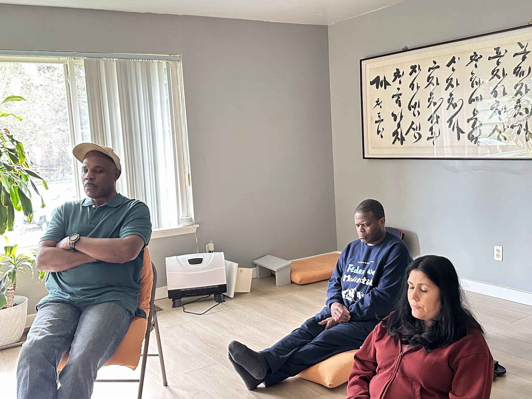 Members meditating together in a group session at the center