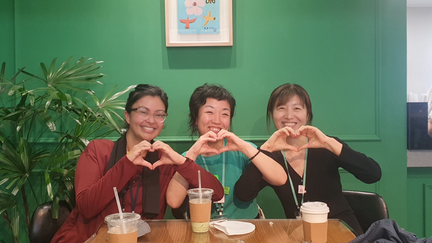 Three members making heart signs together