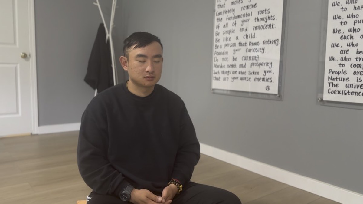 A member sitting in a guided meditation session at the center